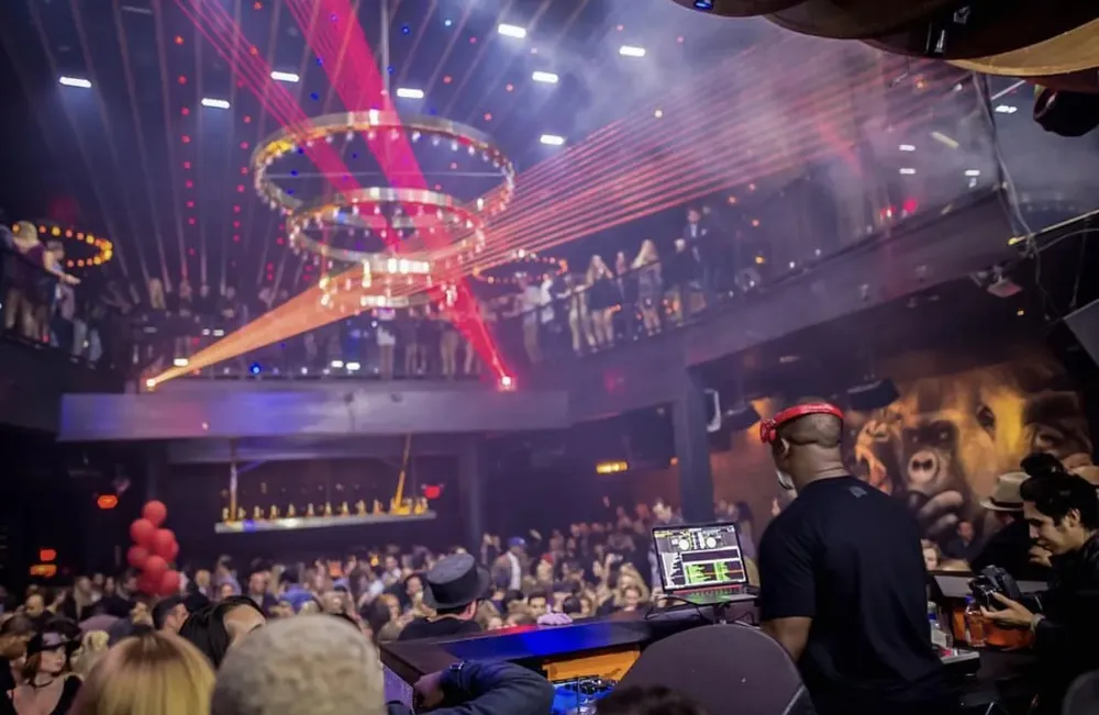 DJ M.O.S. spinning at 1OAK Las Vegas under a laser show